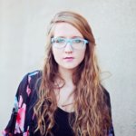 e97d8083 woman in black crop top wearing blue sunglasses taking 192440