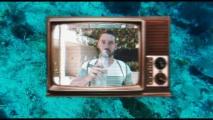 **Alt Text:** A vintage TV screen displays a man drinking from a water bottle, set against an underwater background.