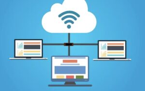 **Alt Text:** A cloud with a wireless symbol connects to three laptop screens displaying graphs and charts, symbolizing cloud computing.