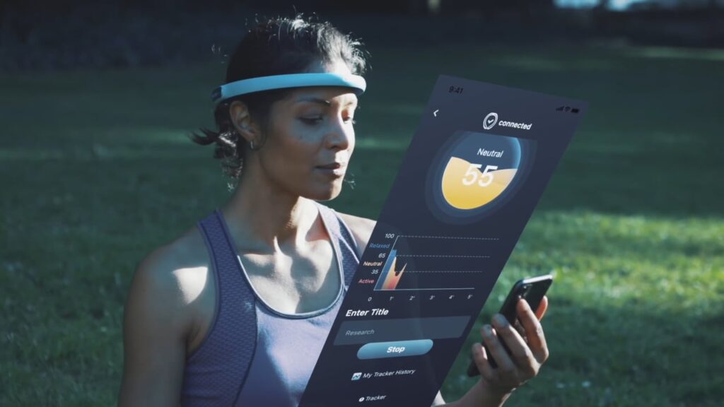 A woman wearing a headband in a park uses a smartphone to monitor her mental state via a projected app interface showing "Neutral 55."