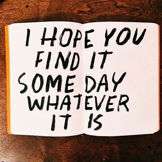 **Alt Text:** An open book on a wooden table displays the handwritten message, "I hope you find it some day whatever it is."