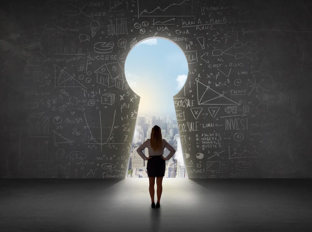 A woman stands in front of a large keyhole-shaped opening in a wall covered with various business and mathematical diagrams, looking out at a bright cityscape.