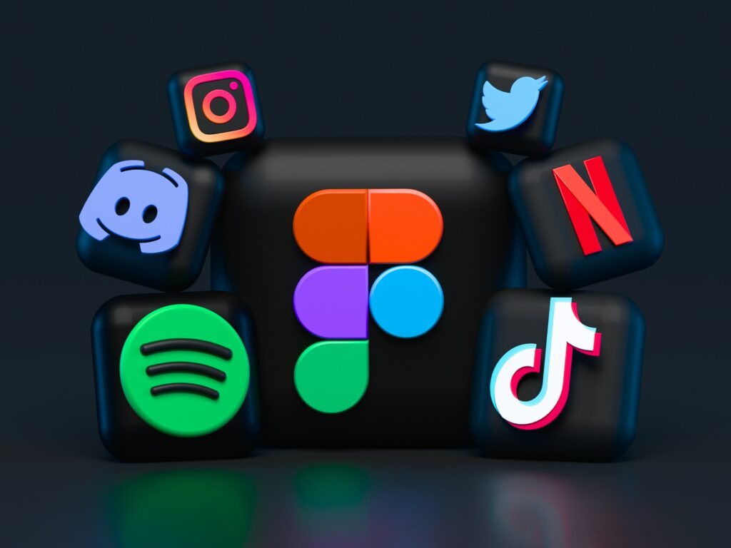 **Alt Text:** A colorful arrangement of 3D social media and streaming app icons, including Instagram, Discord, Spotify, Figma, Twitter, Netflix, and TikTok, against a dark background.