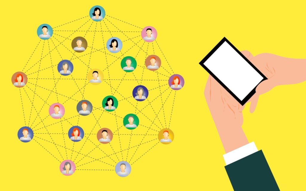 A smartphone held in hand next to a network of interconnected user icons on a yellow background.