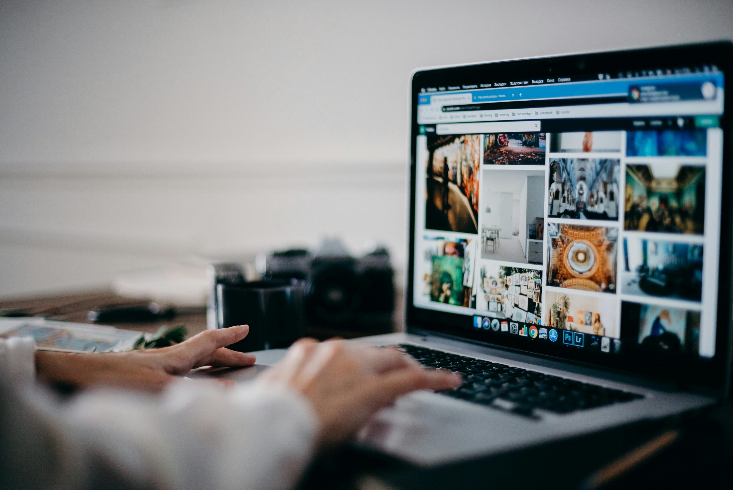 A person browsing a photo gallery on a laptop.