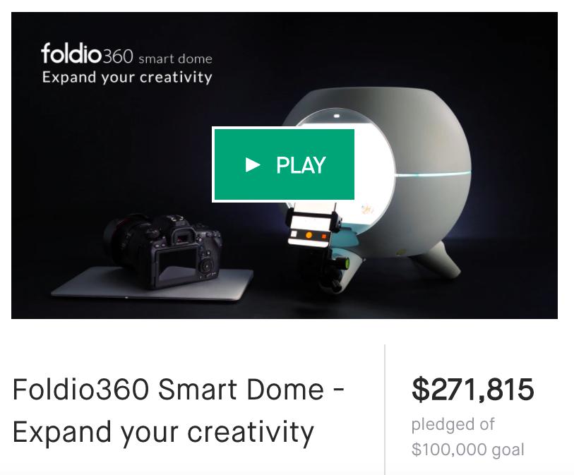A Foldio360 Smart Dome is displayed next to a camera, with a green play button overlay indicating a video.
