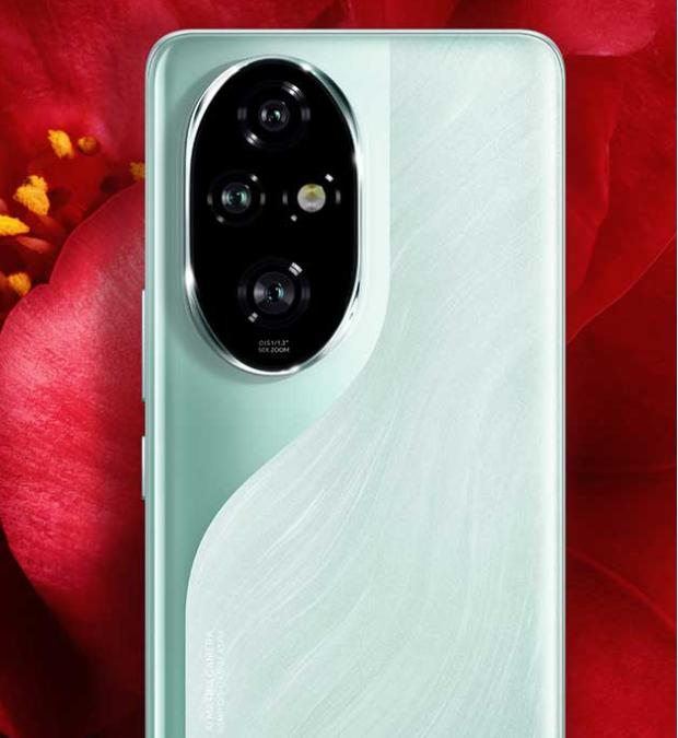 **Alt text:** A close-up of a smartphone with a teal back and triple camera setup, set against a background of red flowers.