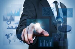 **Alt Text:** A person in a suit is interacting with a digital interface displaying various charts and graphs.