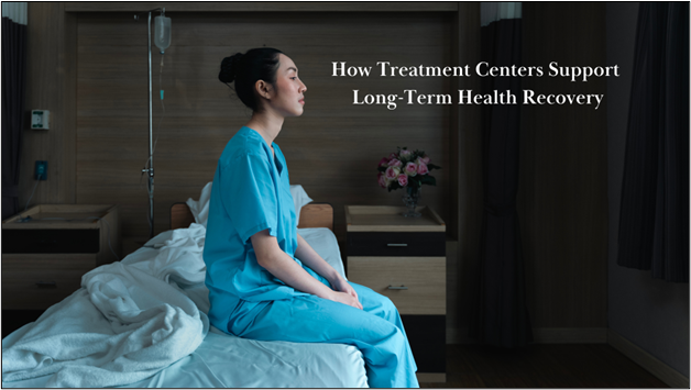 A person in blue hospital scrubs sits on a bed in a dimly lit room with medical equipment and flowers, next to text that reads "How Treatment Centers Support Long-Term Health Recovery."