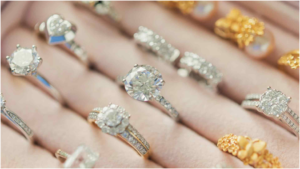 **Alt text:** A display case with various gold and silver rings embellished with large gemstones and intricate designs.