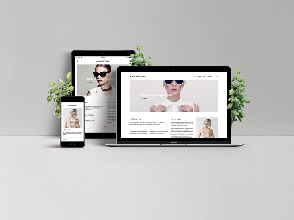 **Alt Text:** A smartphone, tablet, and laptop display a website with a fashion theme, placed on a light gray surface with small green plants beside each device.