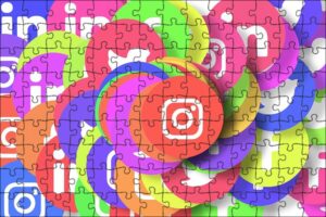 **Alt Text:** A jigsaw puzzle depicting a collage of colorful social media icons, including Instagram, in overlapping circular shapes.