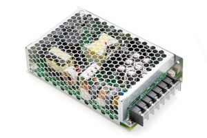 **Alt Text:** A metal-cased electronic power supply with a honeycomb mesh cover is shown, exposing internal components and connectors on one side.