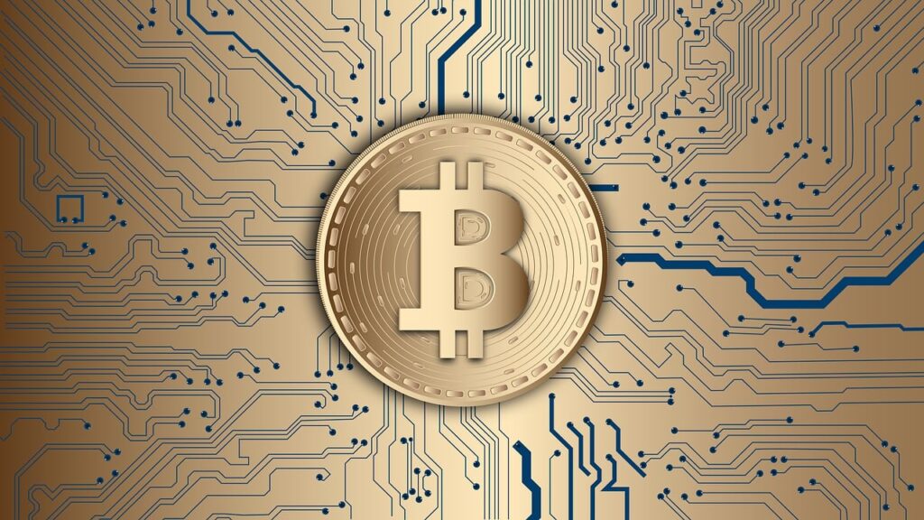 **Alt text:** A gold-colored bitcoin symbol on a digital circuit board background.