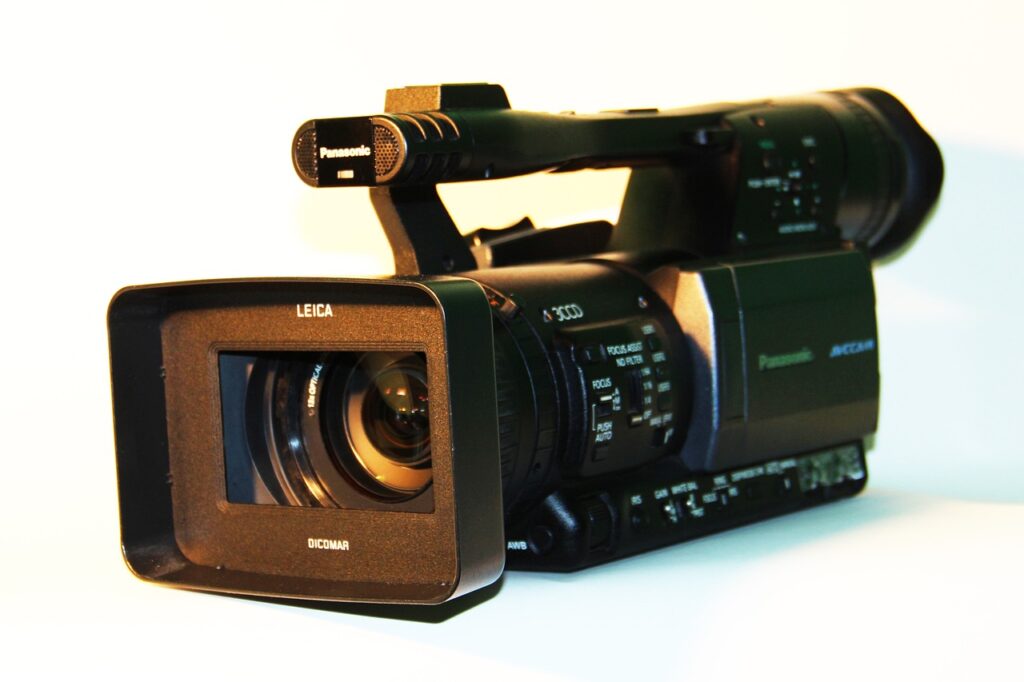 **Alt Text:** Close-up image of a professional video camera with a lens prominently labeled "Leica."