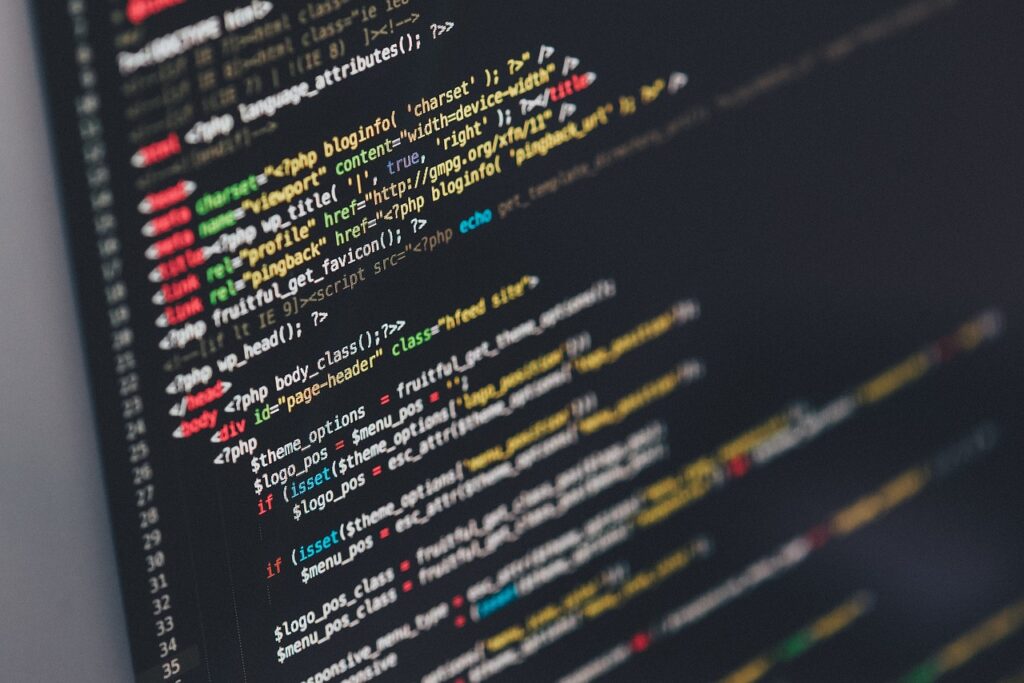 **Alt Text:** A computer screen displaying lines of colorful code written in a programming language.