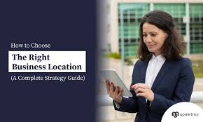 A woman in a business suit looks at a tablet outside, next to text that reads "How to Choose The Right Business Location: A Complete Strategy Guide."