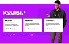 A man holding a phone stands next to a purple background offering three business plans labeled Premium, Advanced, and Enterprise.