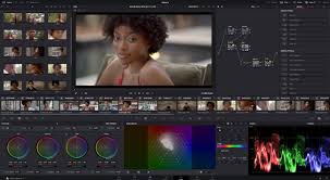 **Alt text:** A video editing software interface displaying a color grading workspace with a video preview of a woman, color wheels, and waveform scopes.
