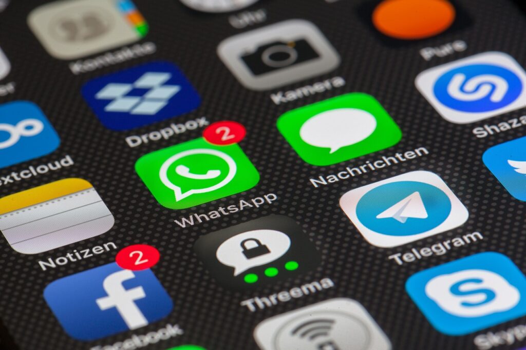 **Alt Text:** A smartphone screen showing various app icons, including WhatsApp with two notifications, Facebook, Telegram, and others.