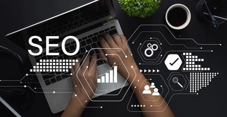 **Alt Text:** A person typing on a laptop with SEO-related graphics, including charts and icons, overlaying the image.