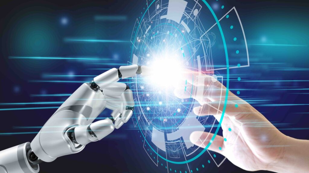 **Alt text:** A robotic hand and a human hand reaching towards each other with a bright digital interface between them.