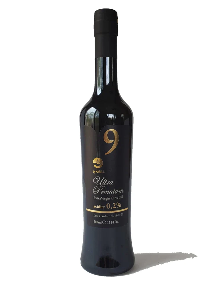 A dark-colored bottle of ultra-premium extra virgin olive oil with gold and white text detailing its low acidity and Greek origin.