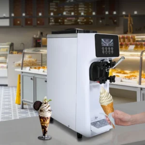 Alt Text: A white soft serve ice cream machine dispensing vanilla ice cream into a cone held by a hand, with a cafe setting in the background and a sundae nearby.