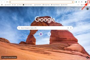 "A Google Chrome browser window with a background image of a natural rock arch, displaying the Google search bar and icons for Google Docs and adding shortcuts."