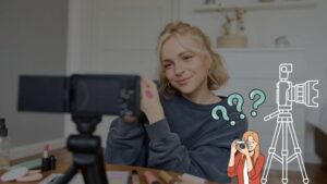A person applies makeup on their hand in front of a camera, surrounded by beauty products on a table, with cartoon illustrations of a photographer and a camera nearby.