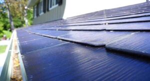 **Alt text:** A close-up view of solar roof tiles on a house.