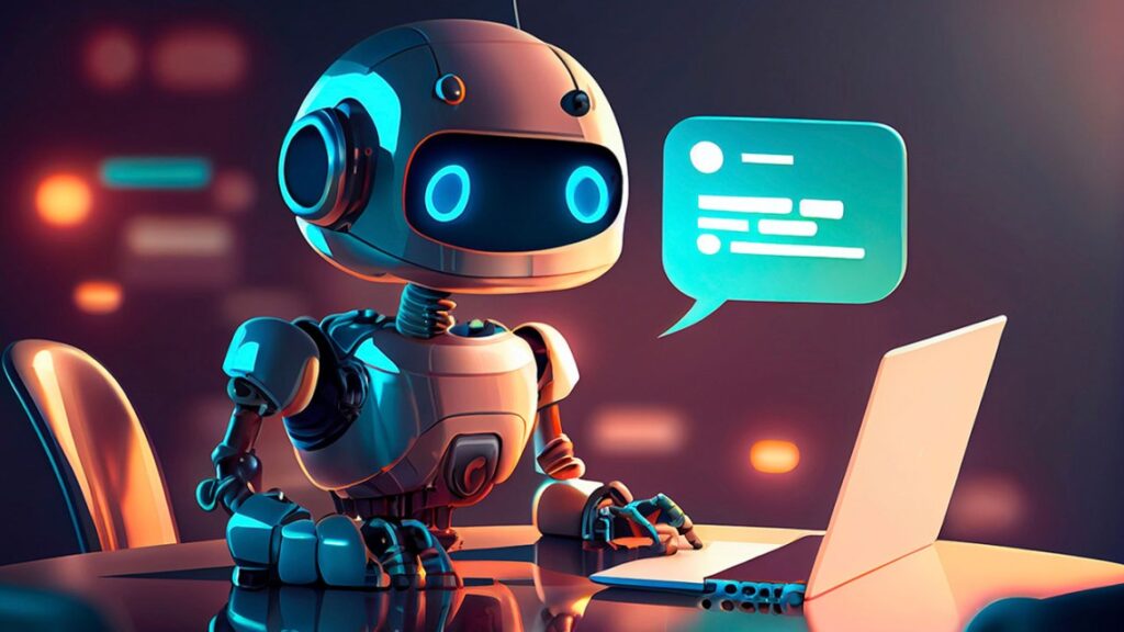 Alt text: A cute robot sitting at a desk using a laptop with a glowing speech bubble above its head.