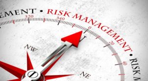 **Alt Text:** A compass with a red arrow pointing towards the words "Risk Management."