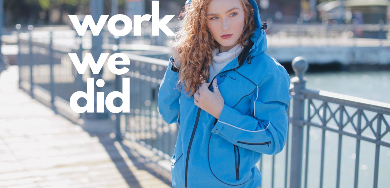 A person in a blue jacket standing by a waterfront pier with the words "work we did" visible on the left.