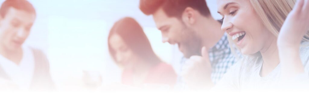 A group of people are laughing and smiling together in an overexposed image.