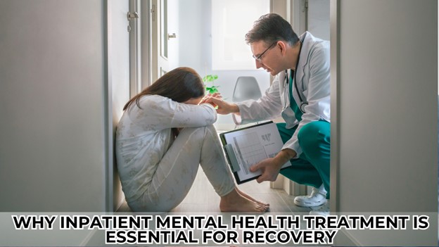 Alt text: A doctor kneels down and speaks to a woman sitting on the floor in a hallway, with a comforting gesture.