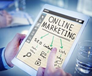 **Alt Text:** A person is using a tablet displaying a digital notebook with the title "Online Marketing," showing arrows pointing to terms like SEO, content, and lists.
