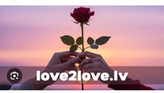 **Alt text:** Two hands hold a single red rose against a pink and purple sunset sky, with the text "love2love.lv" overlaid.